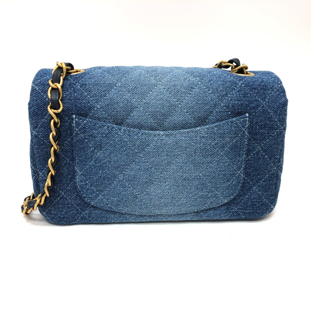 Blue denim handbag with a gold chain on a white background