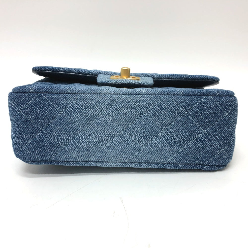 Blue quilted handbag with a gold clasp on a white background