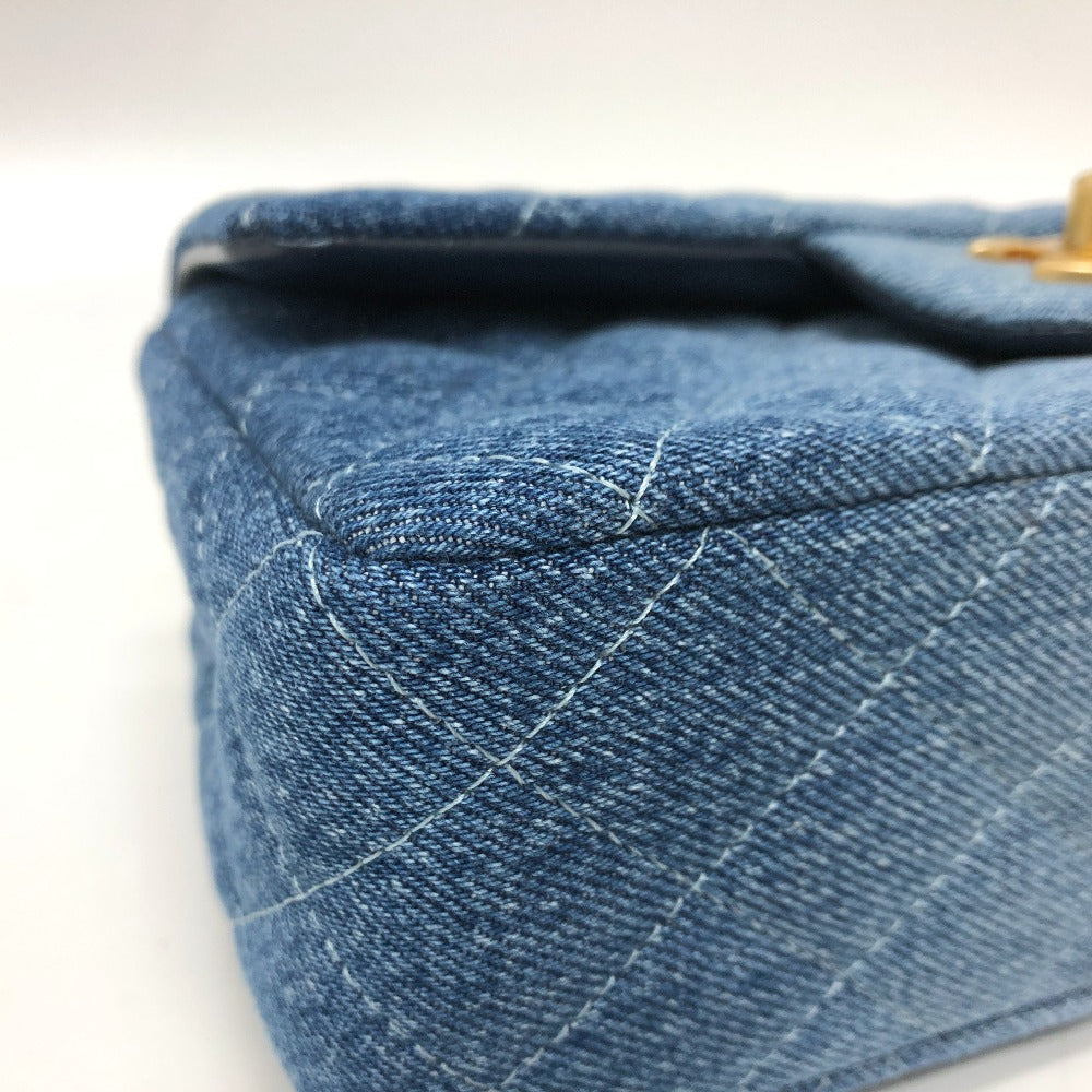 Close-up of blue denim fabric with stitching details on a white background
