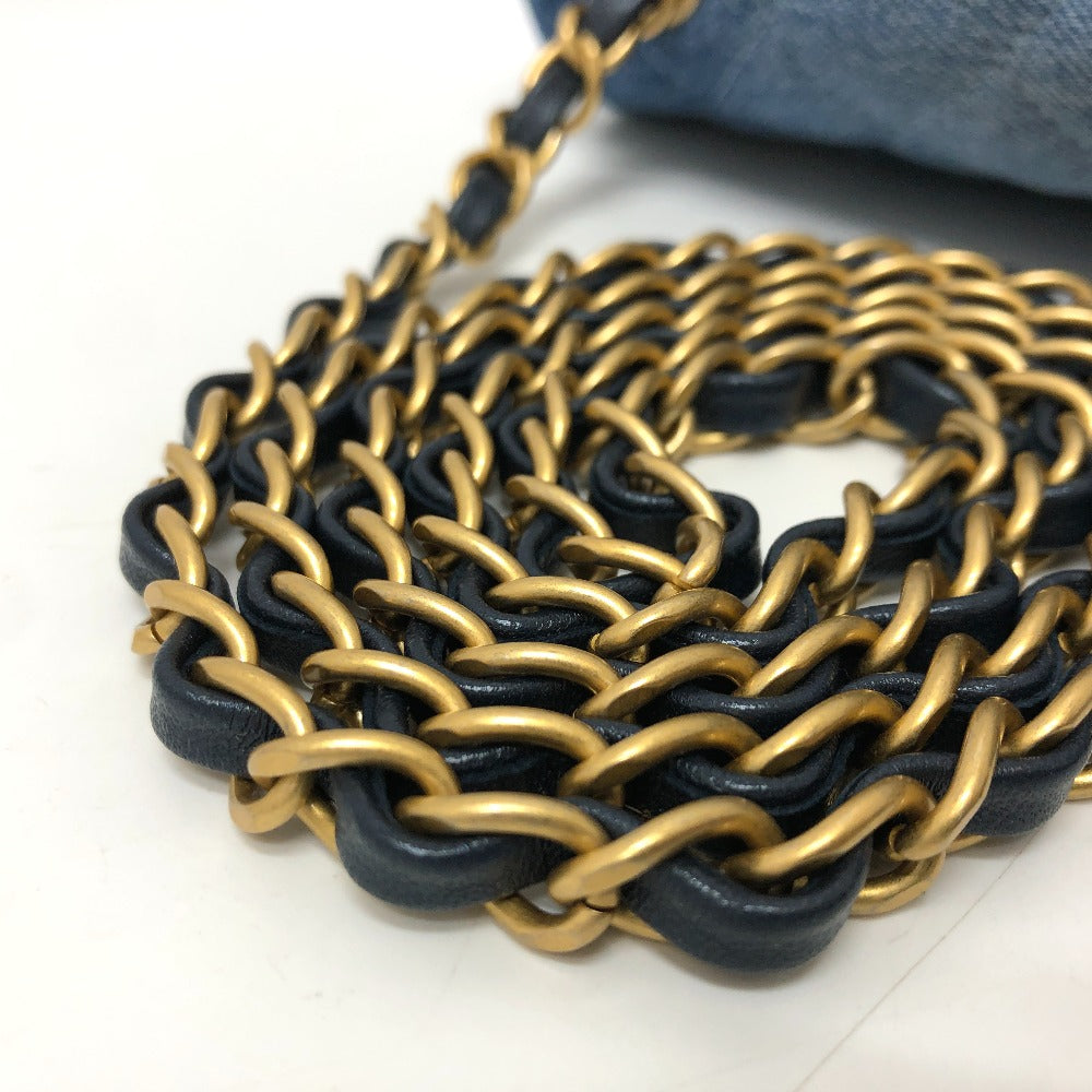 Close-up of a black and gold chain on a white surface