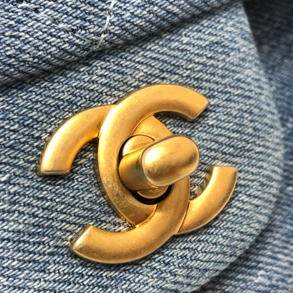 Gold Chanel logo on a denim background