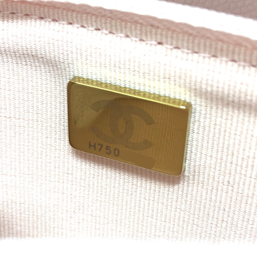 Gold Chanel tag on a beige fabric background