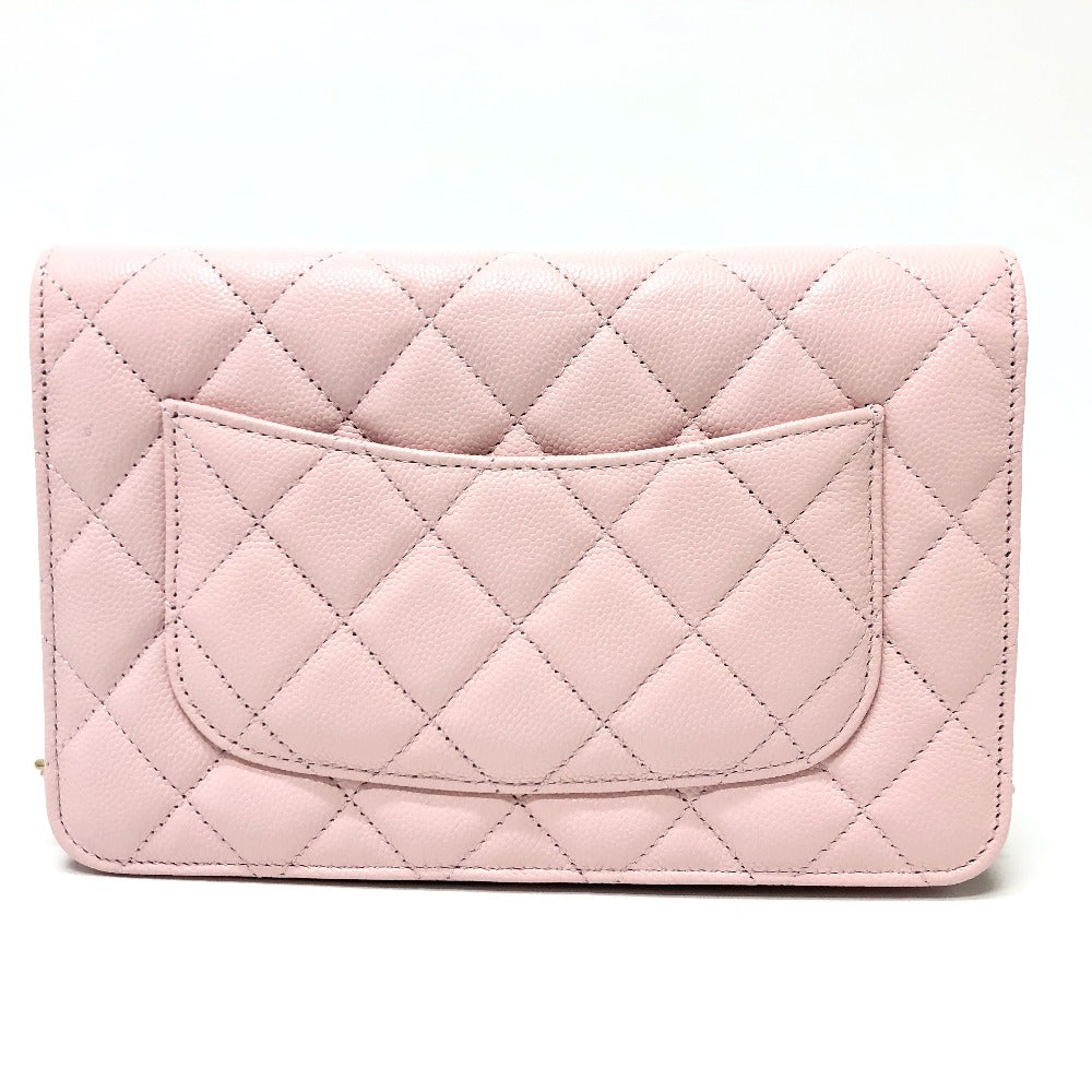 Pink quilted clutch bag on a white background