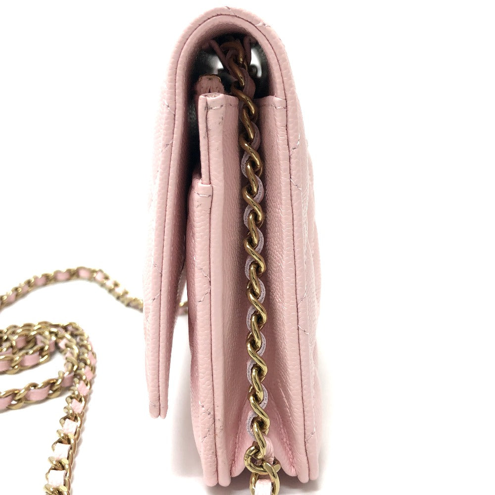 Pink handbag with gold chain strap on a white background