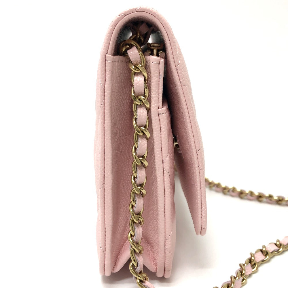 Pink handbag with gold chain strap on a white background