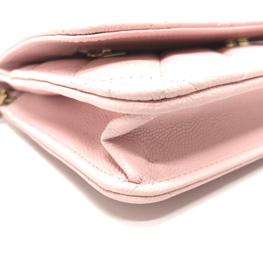 Close-up of a pink handbag with a gold clasp on a white background