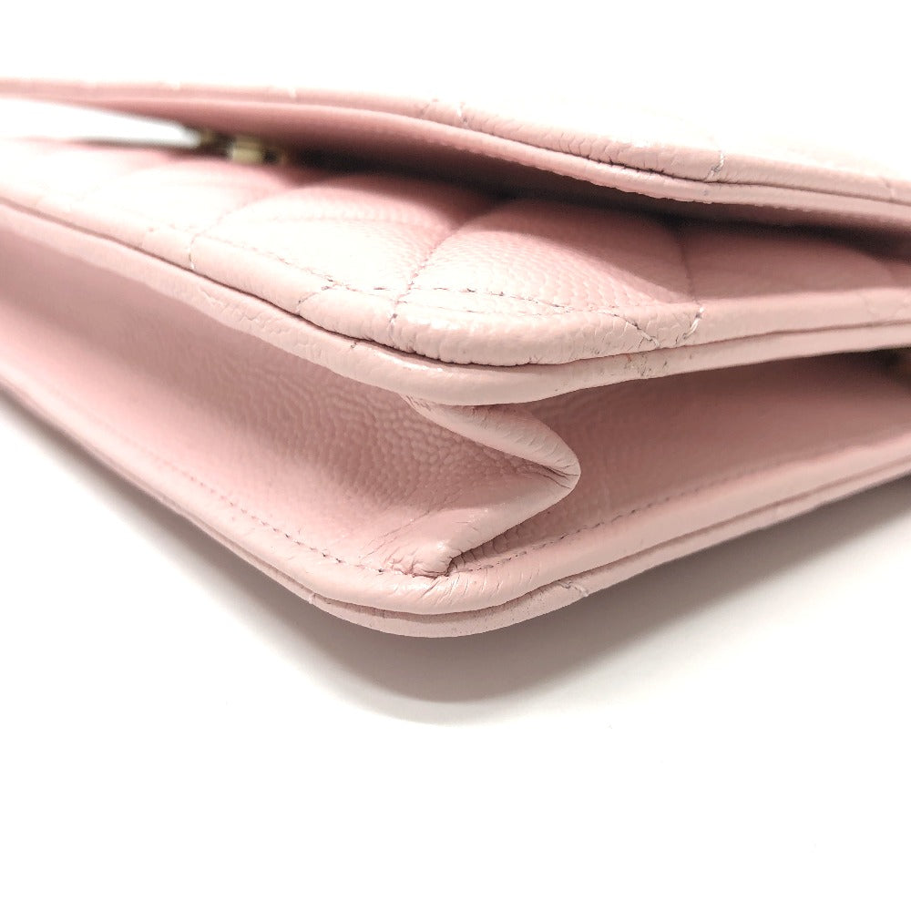 Close-up of a pink quilted handbag on a white background