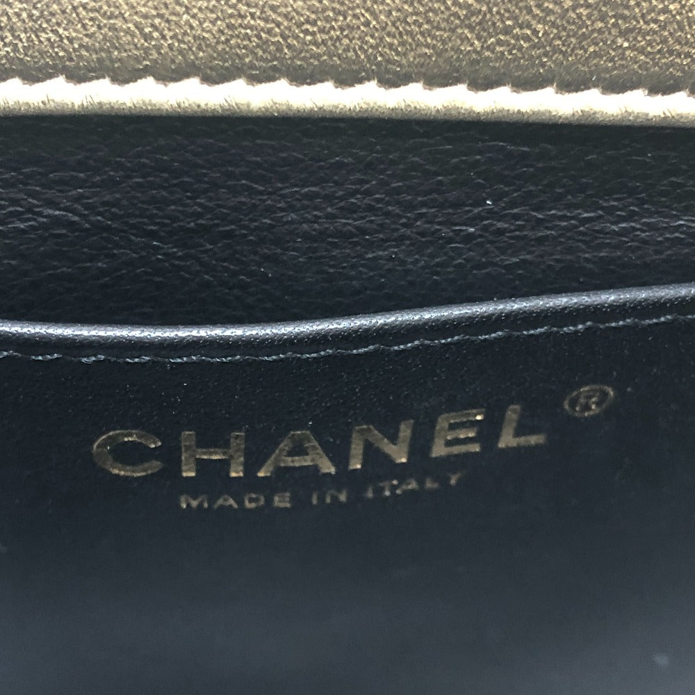 Close-up of Chanel logo on black leather with 'Made in Italy' text.