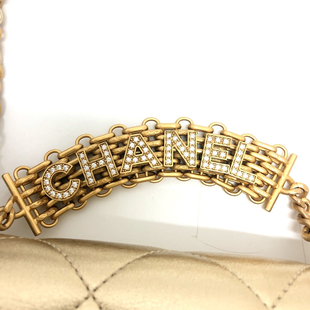 Gold Chanel bracelet with diamonds on a white background