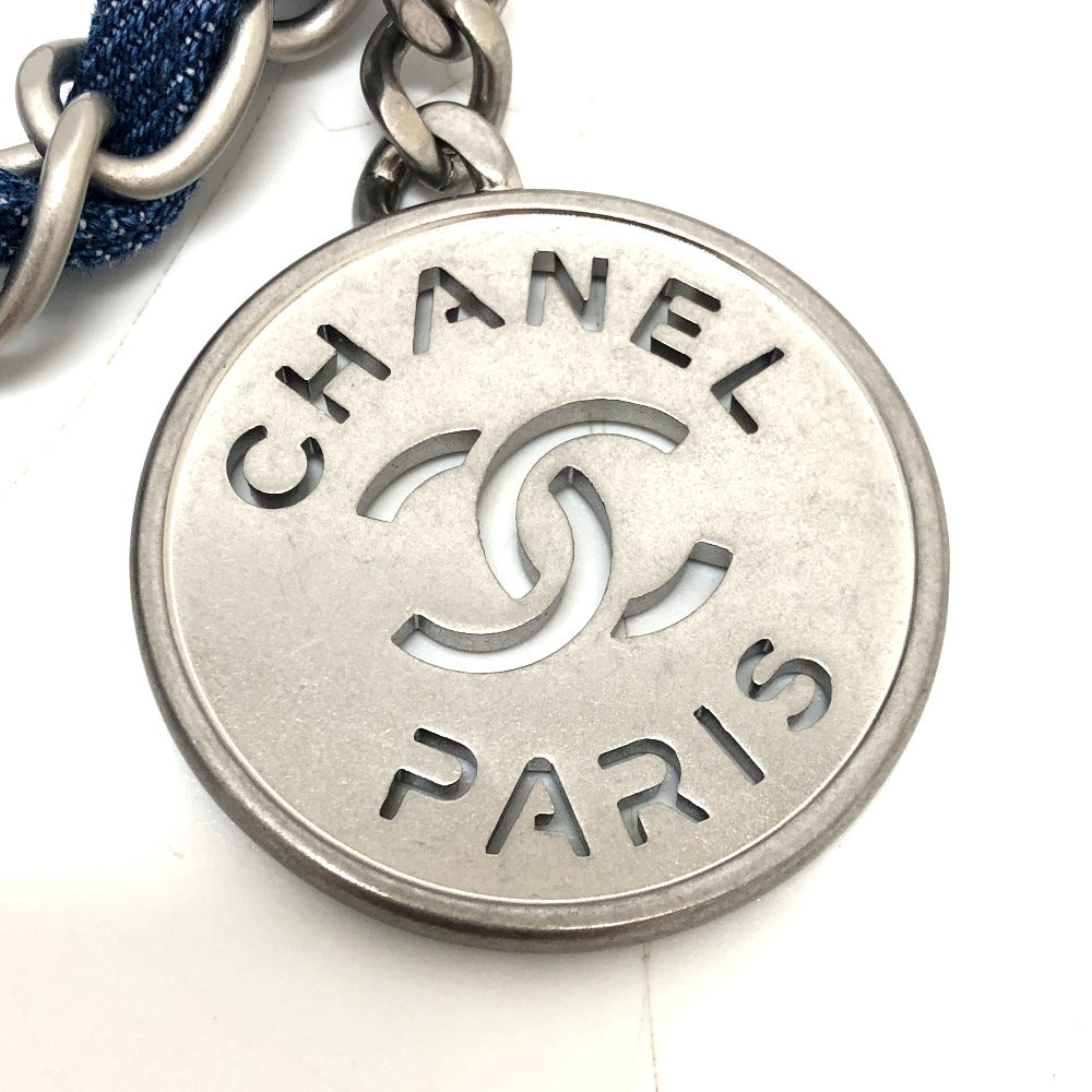 Chanel Paris charm with silver logo and text on a white background