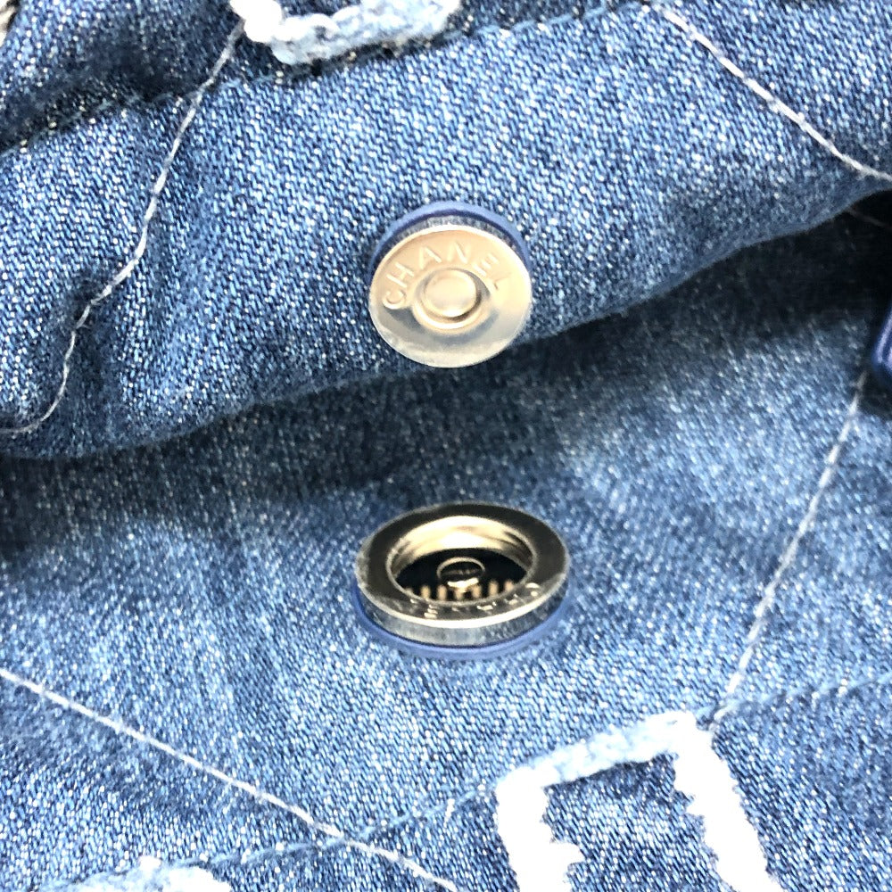 Close-up of a button on blue denim fabric