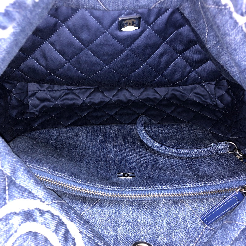 Close-up of a blue quilted handbag with a visible brand logo.