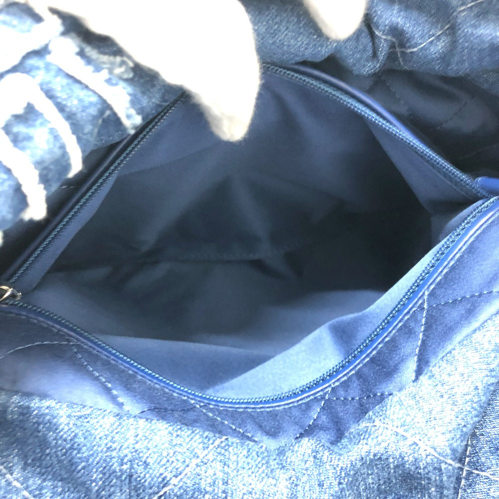 Close-up of a blue denim bag with a zipper
