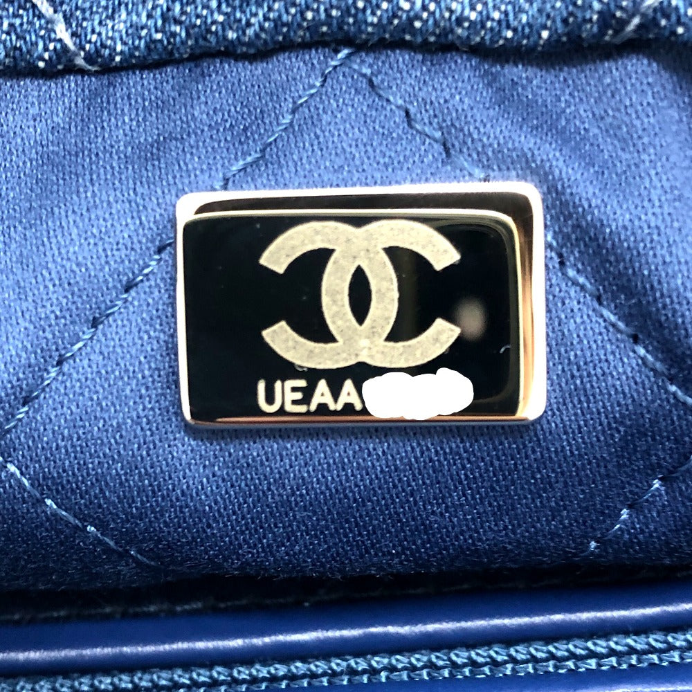 Chanel logo on a blue quilted handbag with 'UEAA' text.