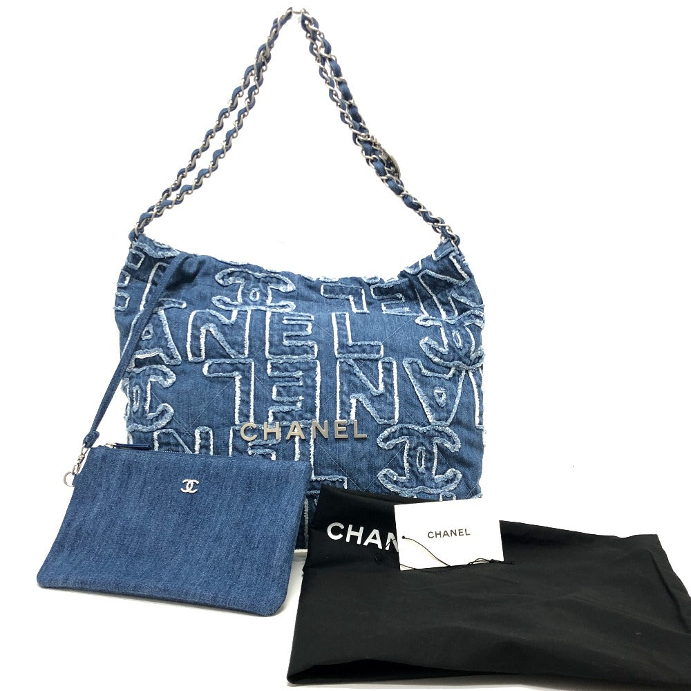 Chanel denim handbag with chain strap, dust bag, and authenticity card on a white background