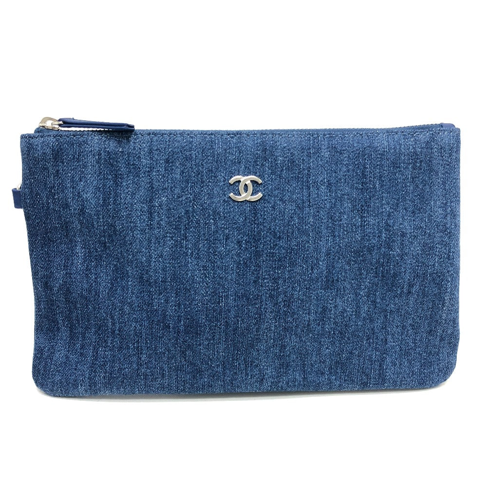 Blue denim clutch bag with Chanel logo on a white background