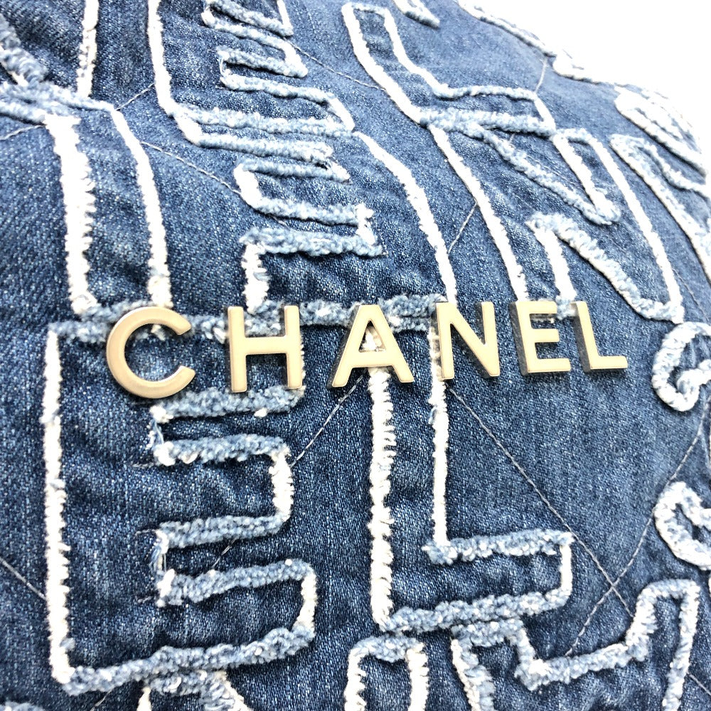 Close-up of a Chanel logo on denim fabric with intricate stitching details.