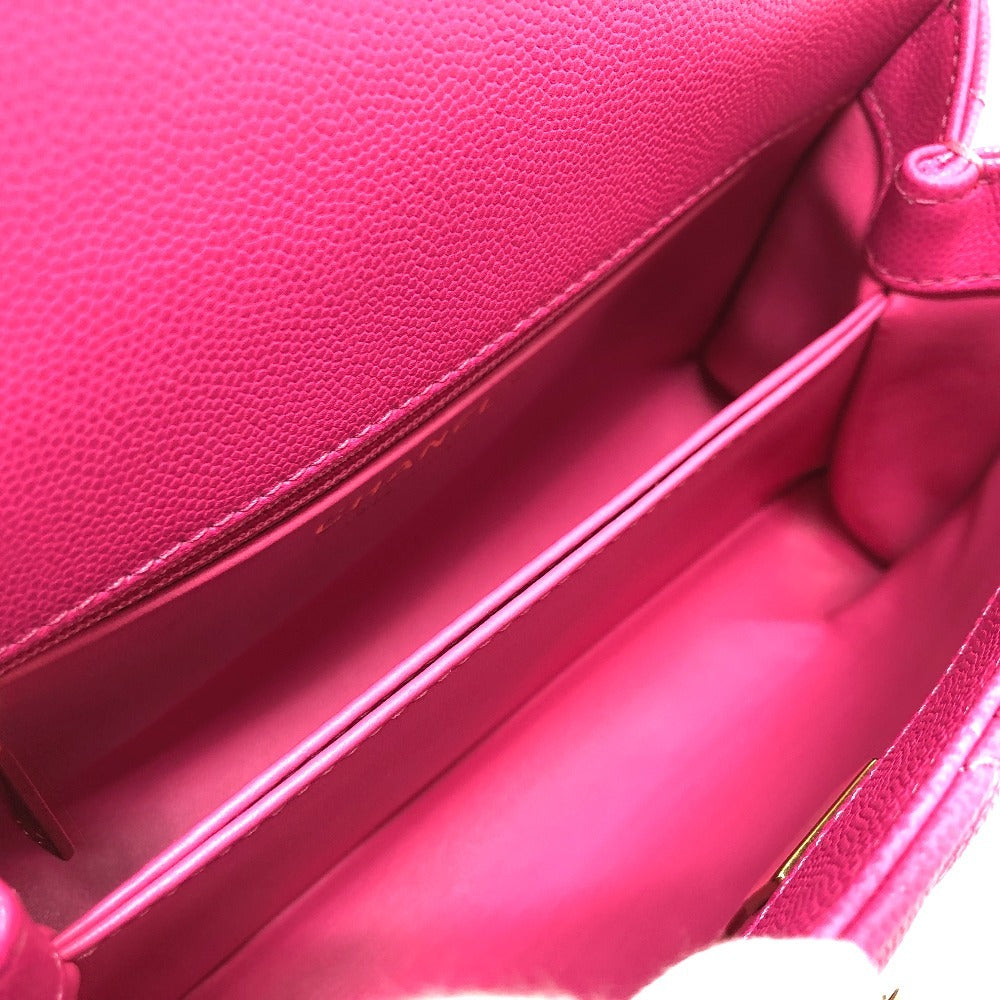 Close-up of a pink leather handbag with a visible brand logo.