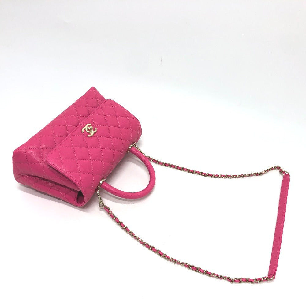 Pink quilted handbag with a chain strap on a white background