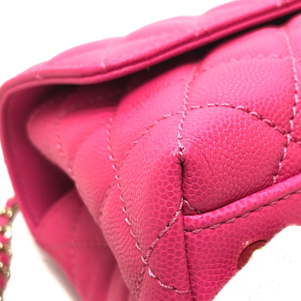 Close-up of a pink quilted handbag with visible stitching details.