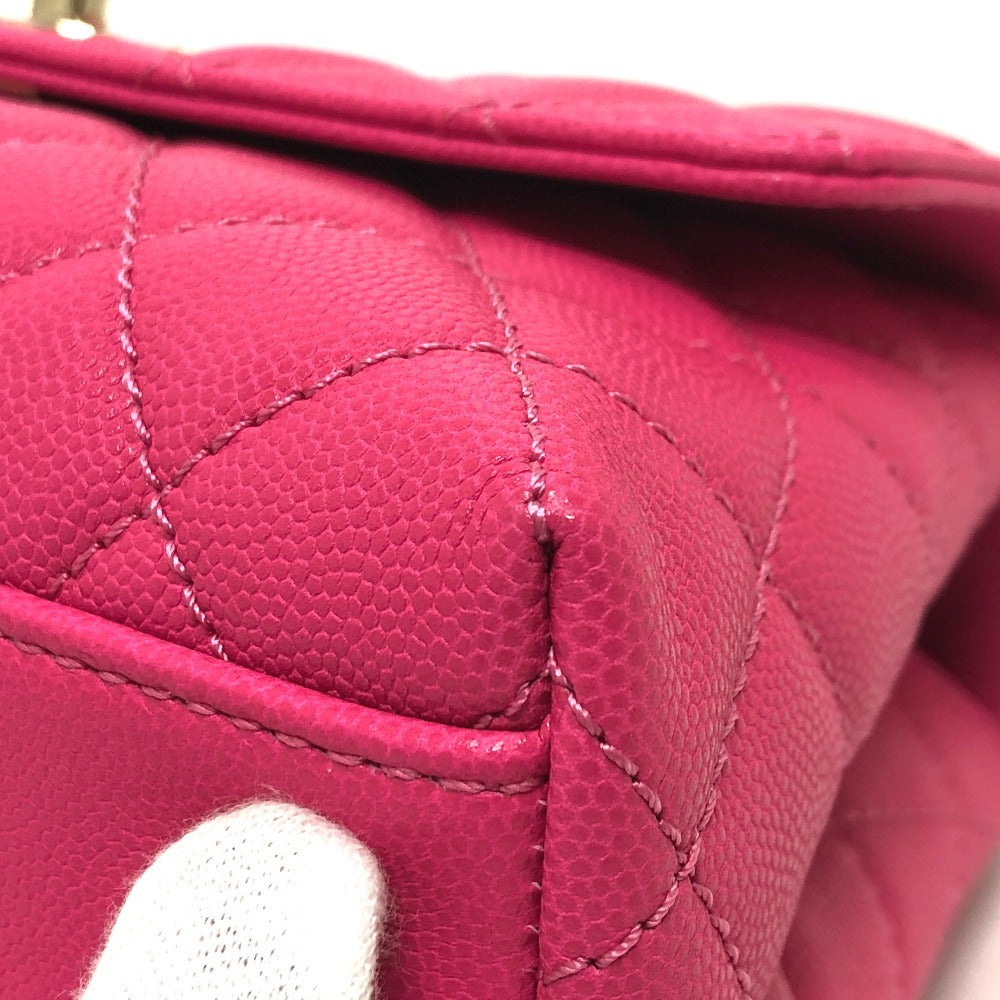 Close-up of a pink quilted handbag with visible stitching