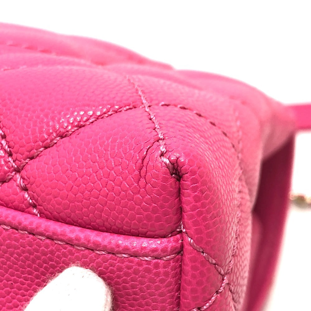 Close-up of a pink quilted handbag with visible stitching details.