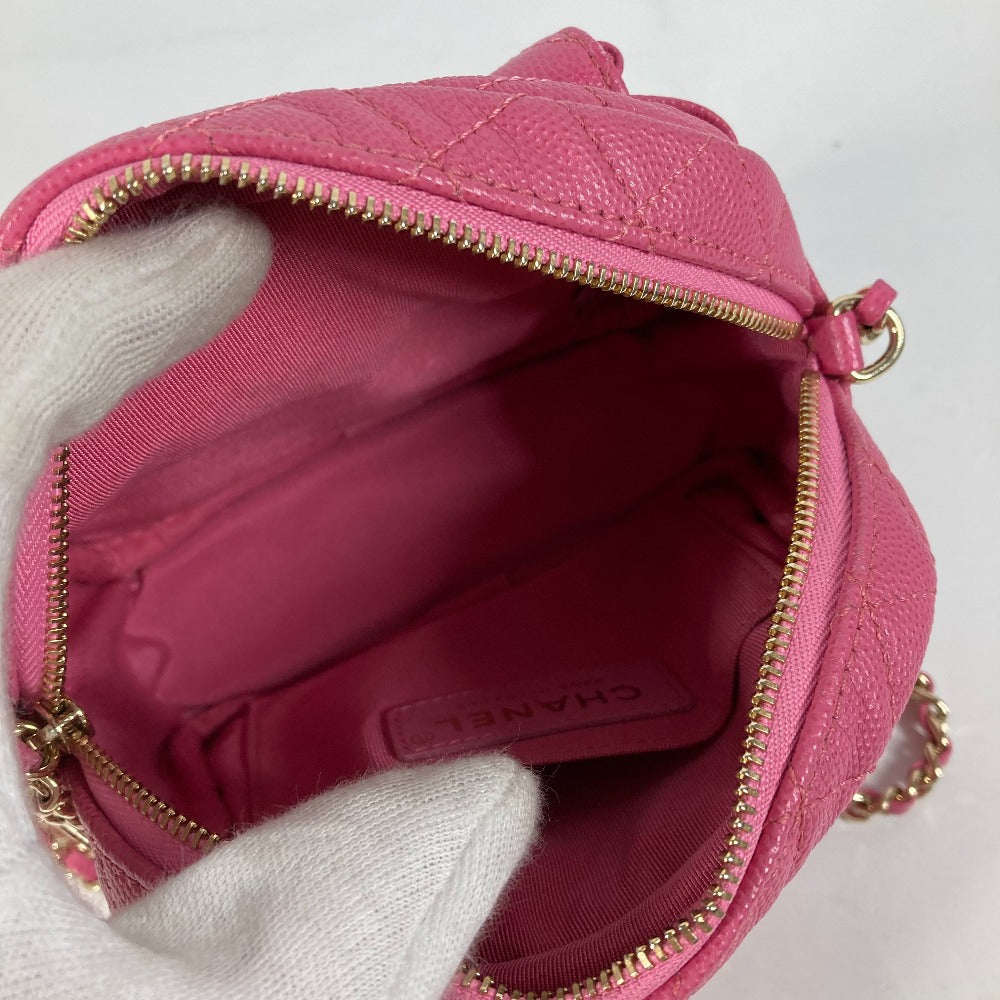 Pink handbag with gold zipper and 'Chanel' branding on a white background
