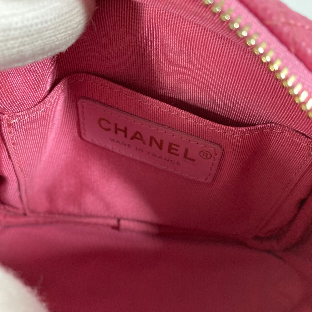 Close-up of a pink Chanel handbag with visible logo.