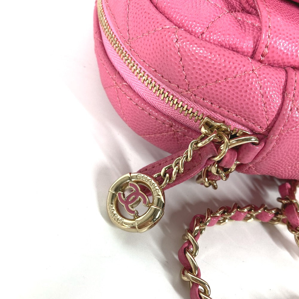 Pink handbag with gold chain strap on a white background