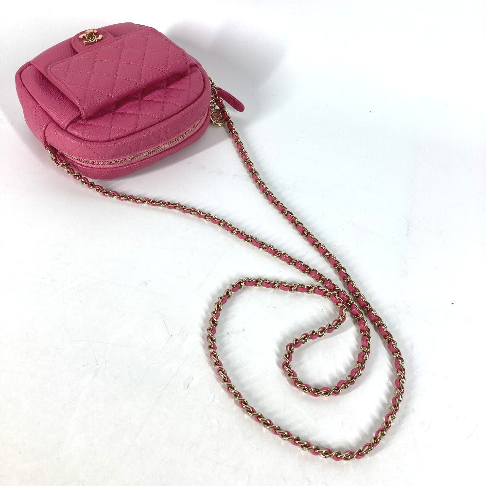 Pink quilted handbag with a chain strap on a white background