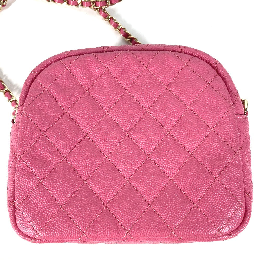 Pink quilted handbag with a chain strap on a white background