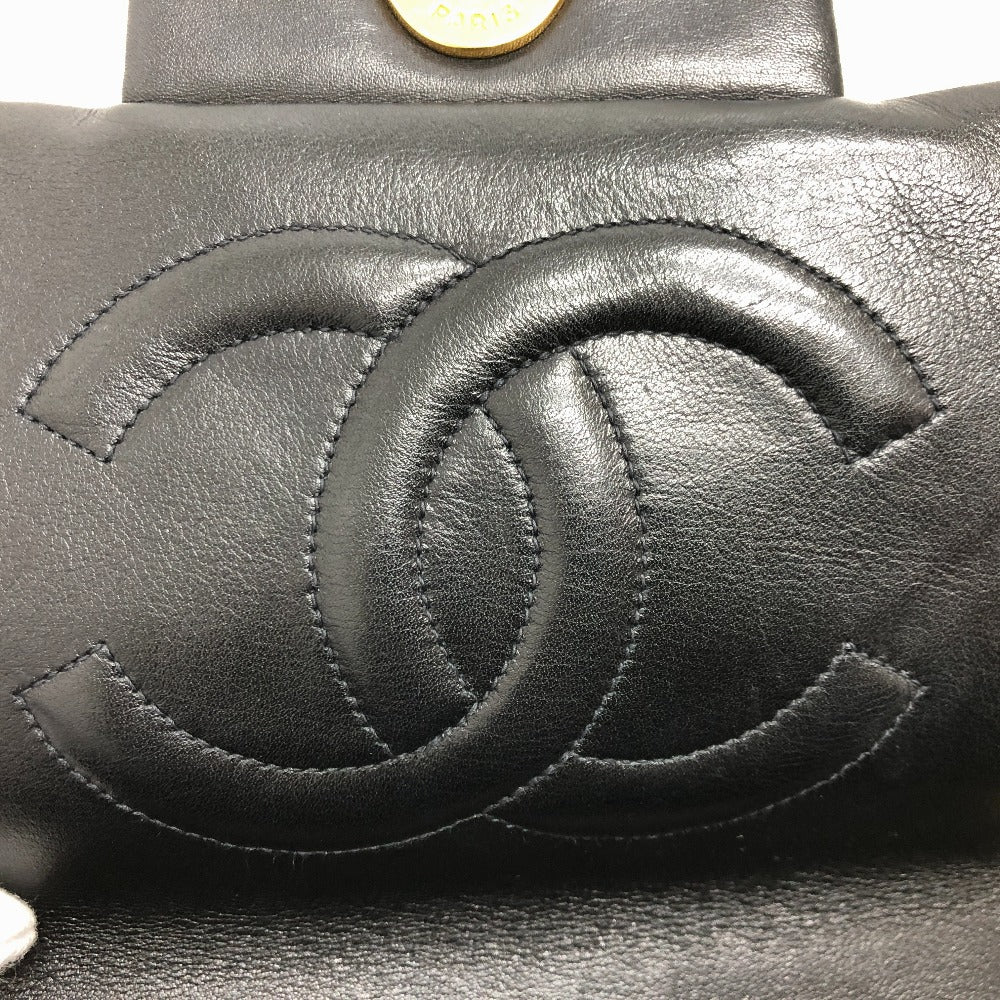 Close-up of a black leather Chanel handbag with the brand's logo.
