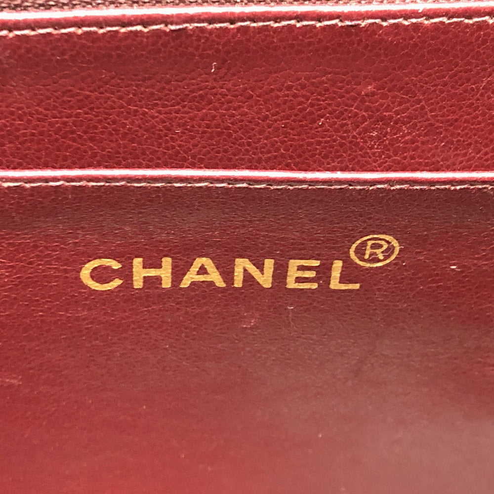Close-up of a red Chanel wallet with gold lettering.