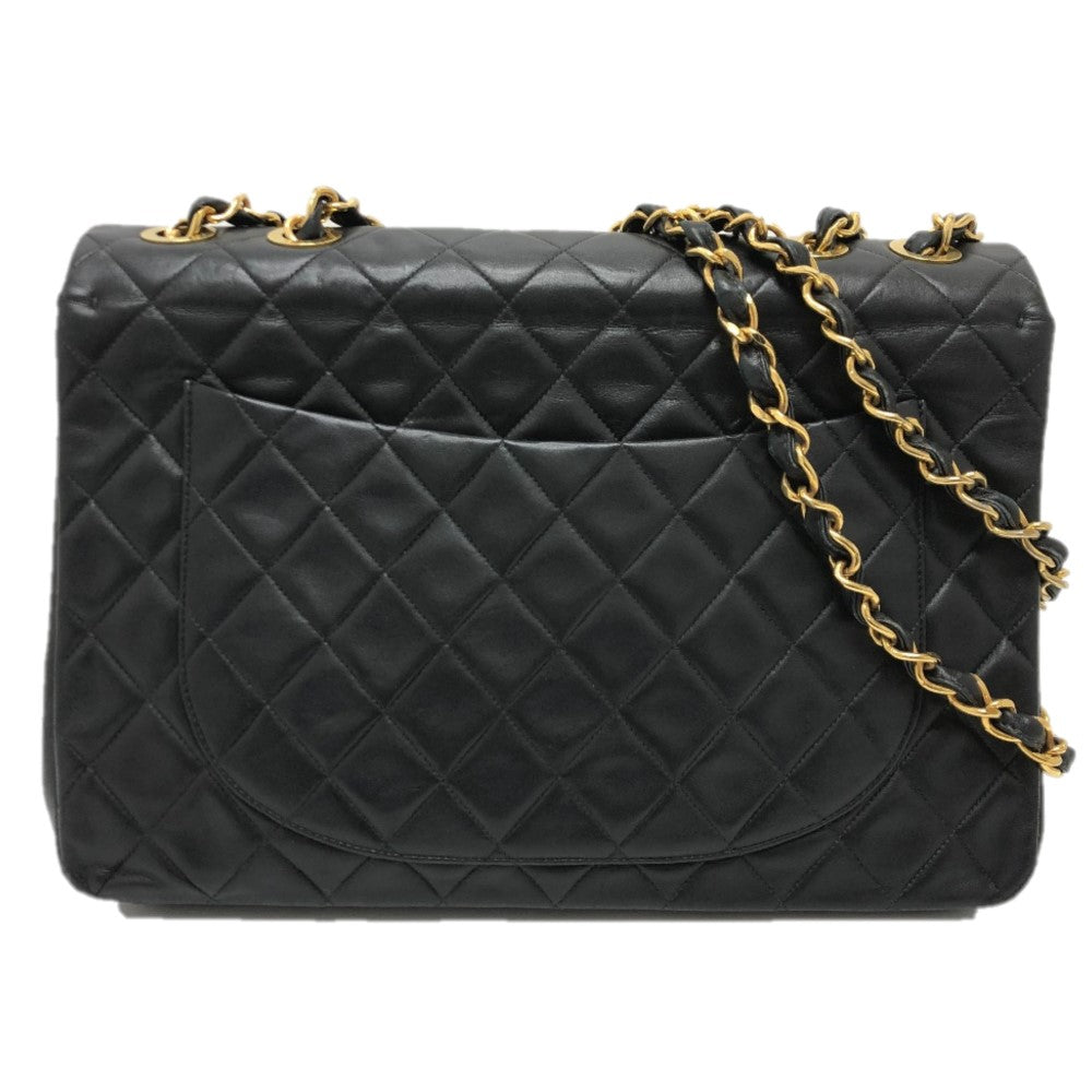 Black quilted handbag with gold chain strap on a white background