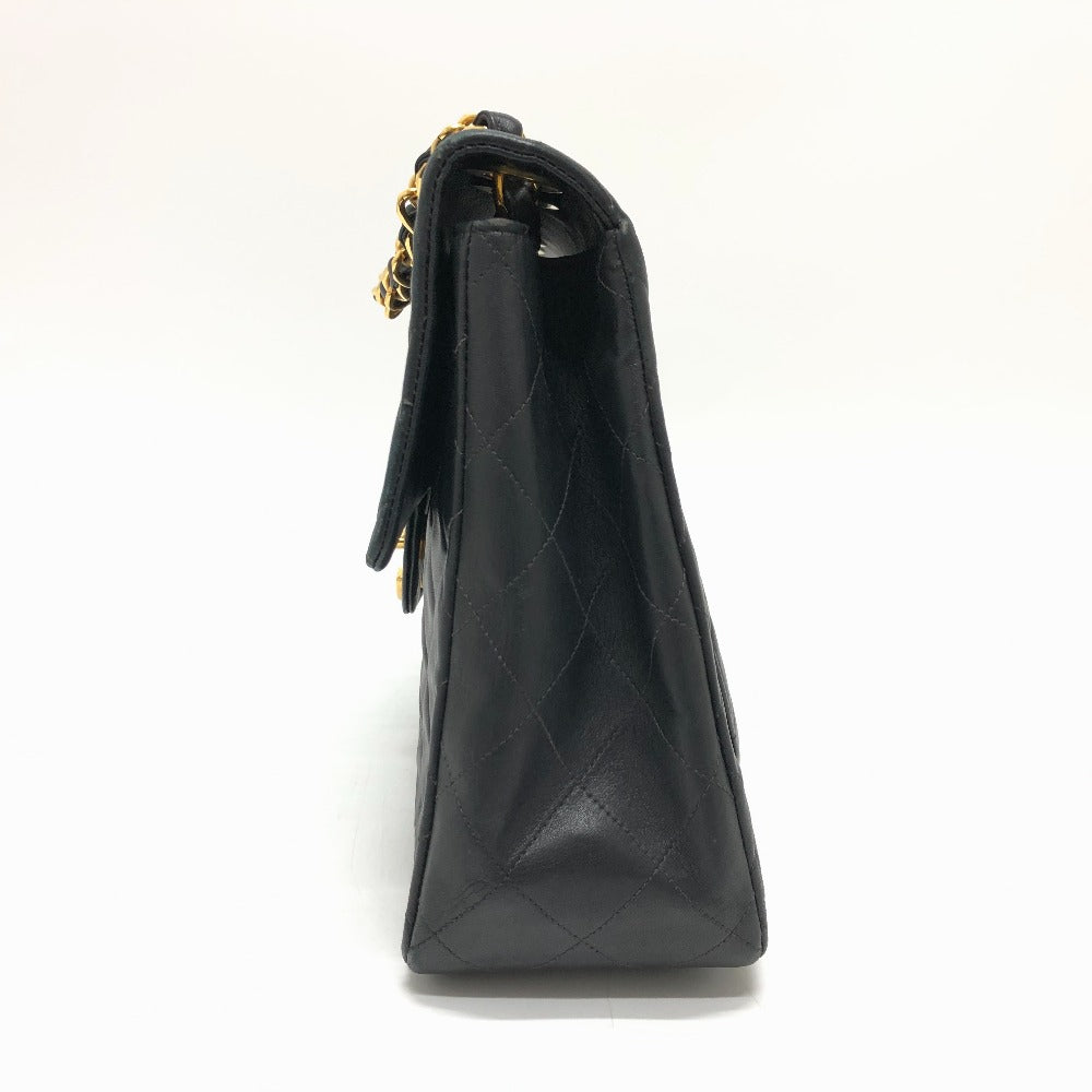 Black handbag with gold chain strap on a white background