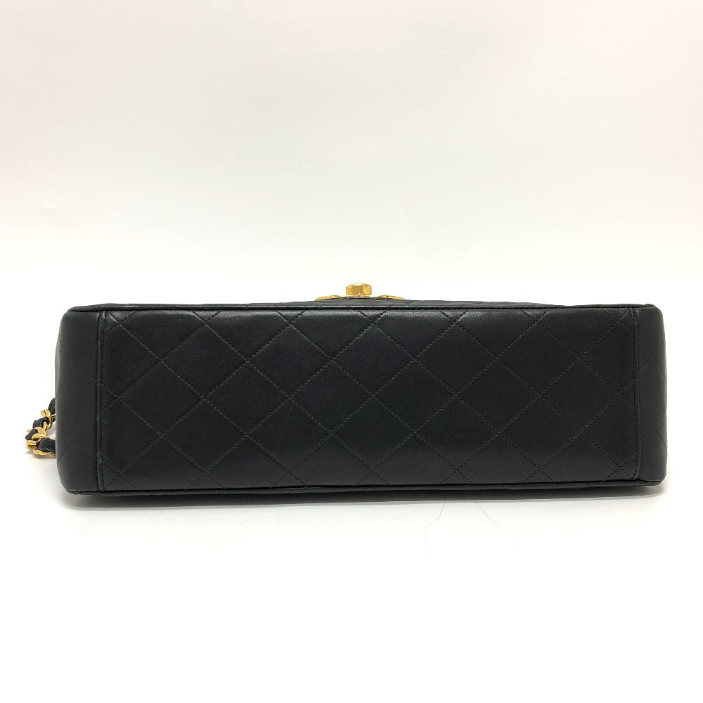 Black quilted handbag on a white background