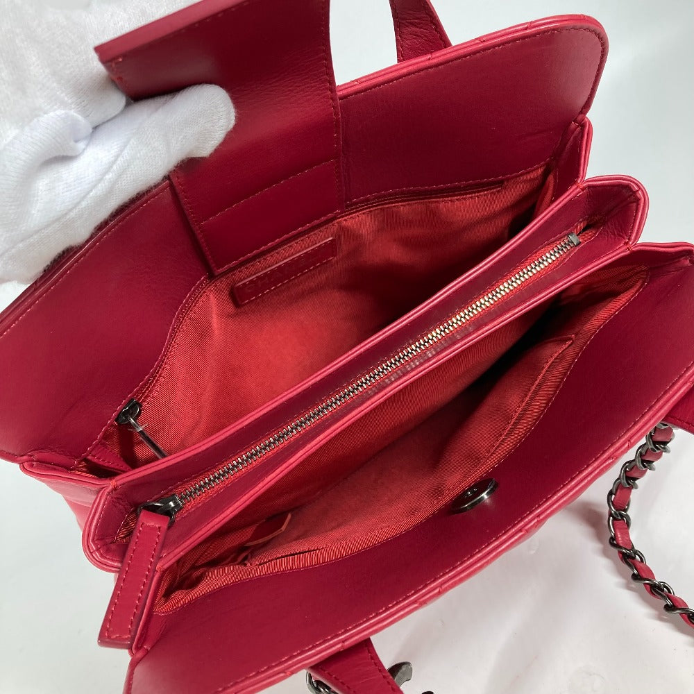 Red handbag with a chain detail on a white background