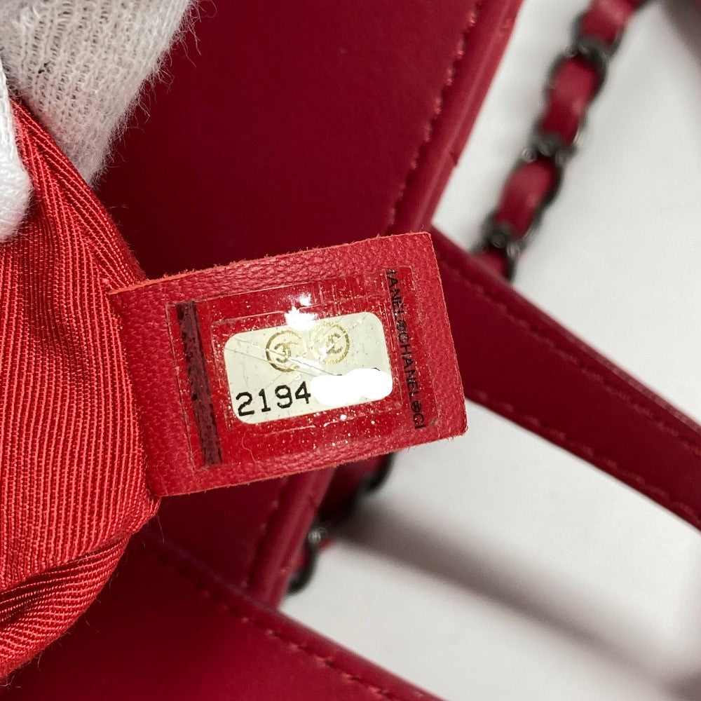 Close-up of a red handbag with a visible label and number.