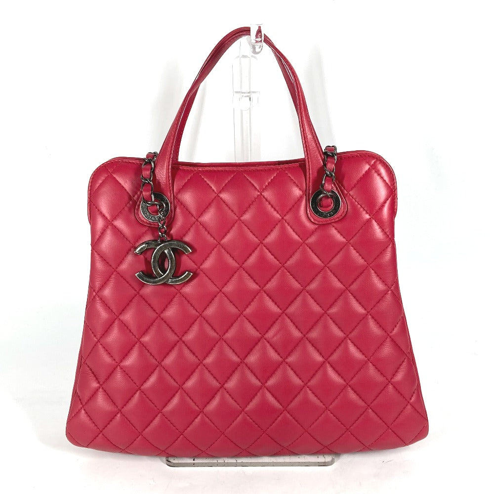 Pink quilted handbag with Chanel logo on a white background