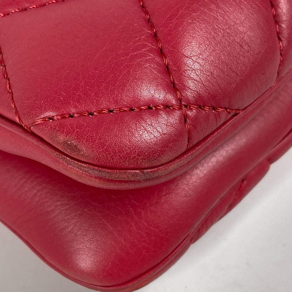 Close-up of a red leather product with visible stitching on a white background