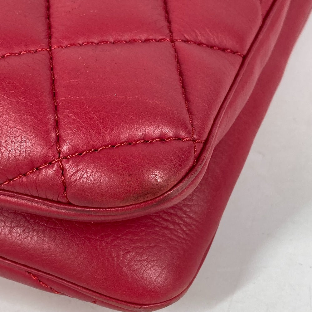 Close-up of a red quilted leather bag on a white background