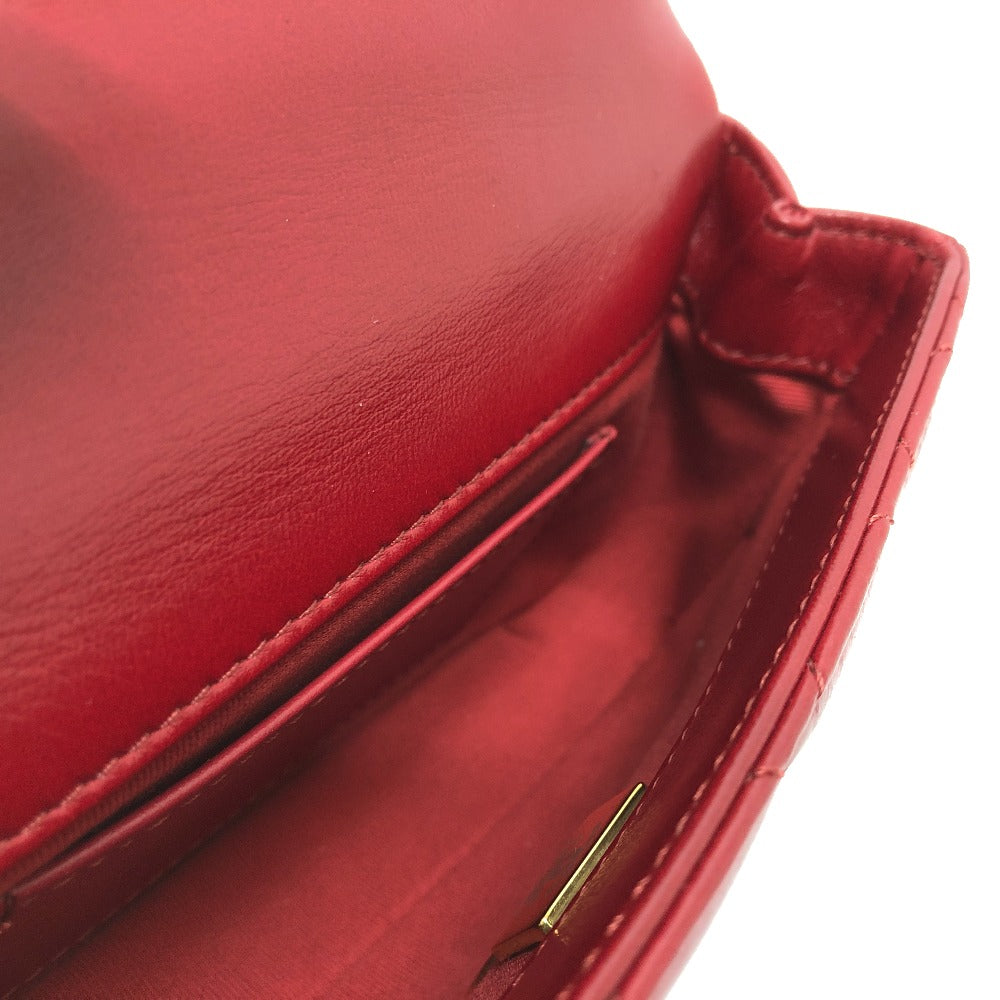 Close-up of a red leather wallet with a gold clasp on a white background