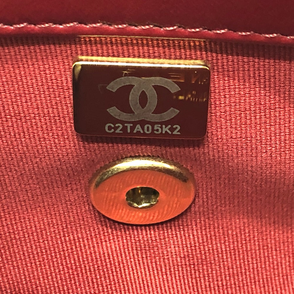 Chanel logo tag and button on a red fabric background
