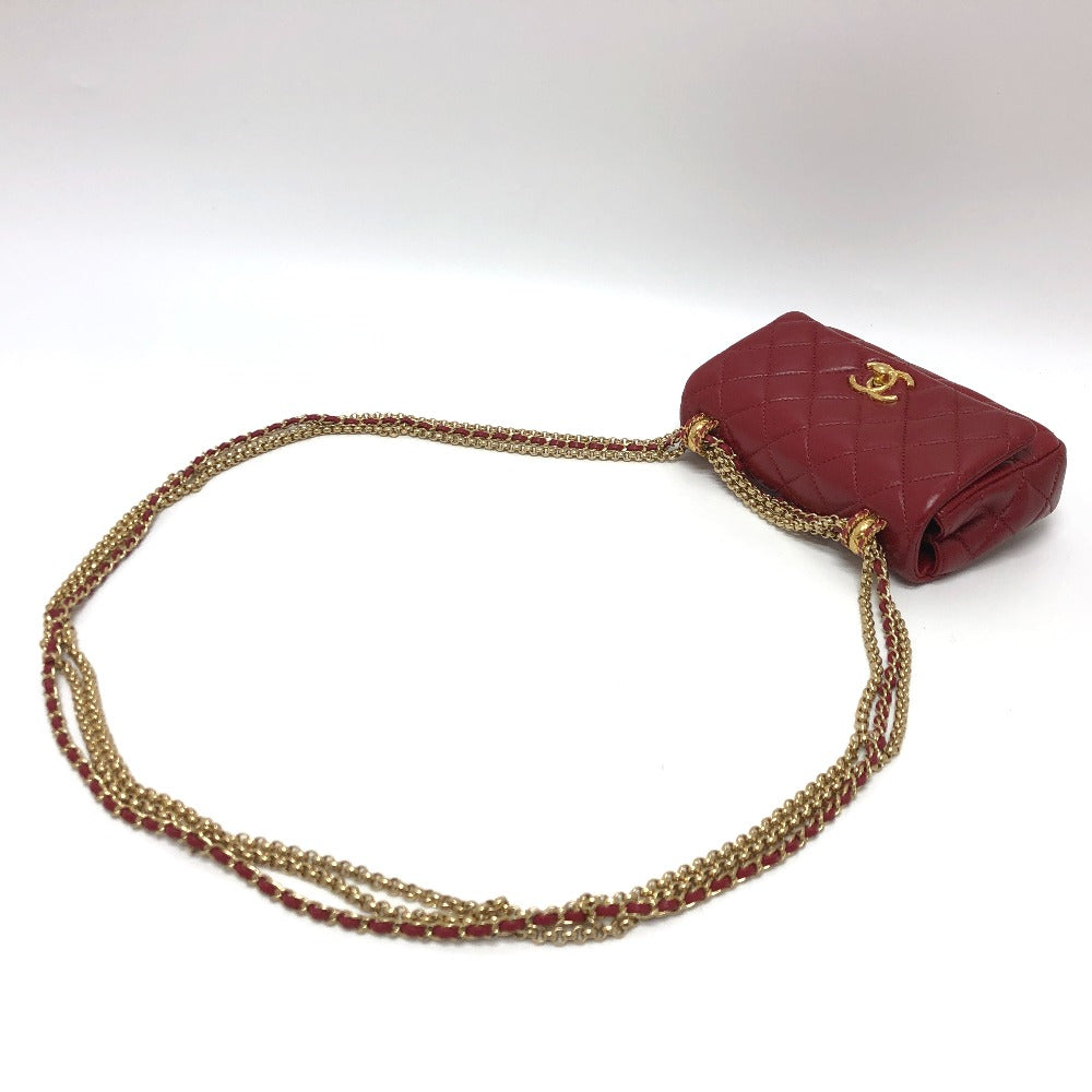 Red handbag with gold chain strap on a white background