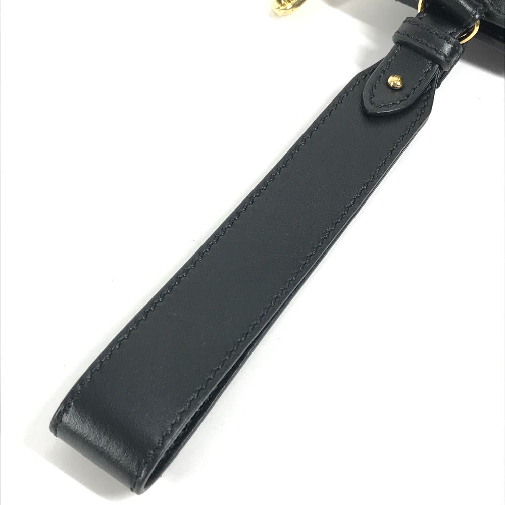 Black leather strap with gold hardware on a white background