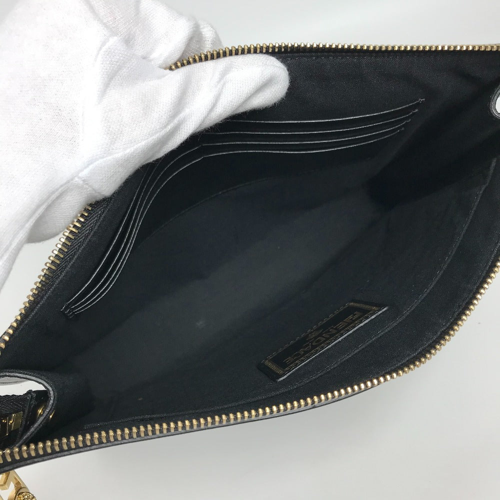 Black handbag with gold zipper on a white background