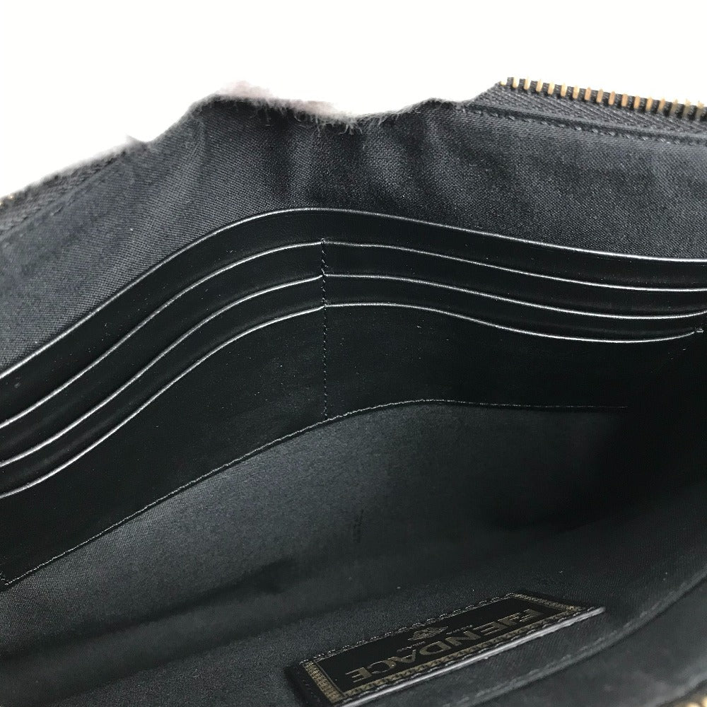 Close-up of a black leather wallet with visible stitching and a brand label on a white background.
