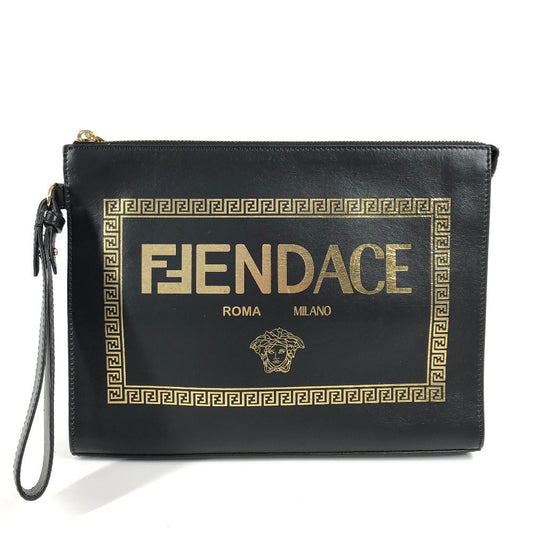 Black clutch bag with gold 'FENDACE' text and logo on a white background