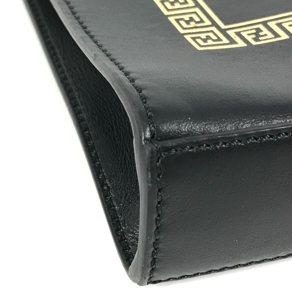 Close-up of a black leather wallet with gold embroidery on a white background