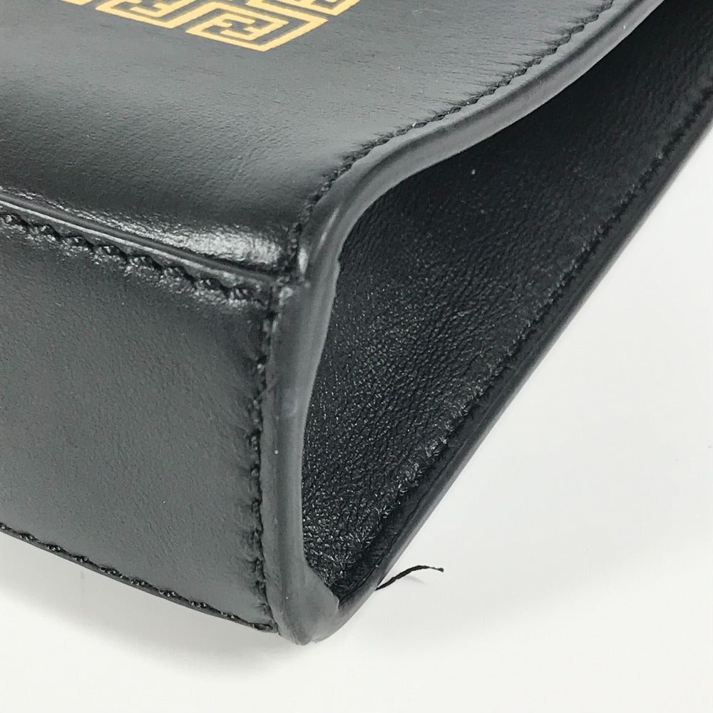 Close-up of a black leather wallet with gold stitching on a white background